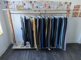 a rack of clothes in a room with a lot of clothes on it