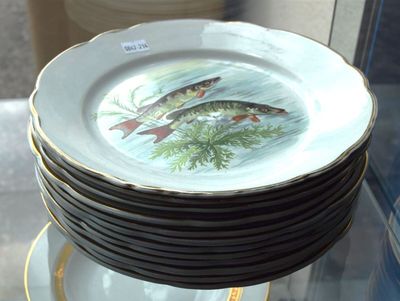 a stack of plates with fish on them on a glass table