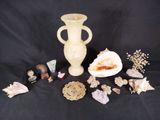 a lot of shells and a vase on a black background