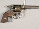 a close up of a revolver on a table with a white background