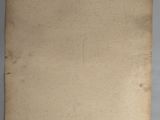 an old piece of paper on a gray surface