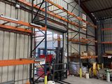 a large warehouse with a lot of shelves and pallets
