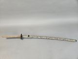 a small silver and black object on a white surface