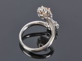 a close up of a diamond ring on a black surface
