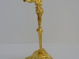 a gold figurine of a man holding a basketball ball