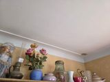 many vases and vases on a shelf in a room