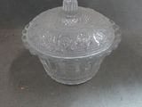 a clear glass bowl with a lid on a table