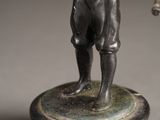 a bronze statue of a man holding a baseball bat