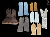 several pairs of gloves are lined up on a black surface