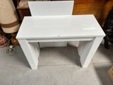 a white desk with a laptop on top of it