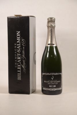 the bottle of champagne is next to a box of wine