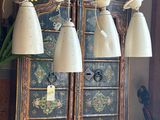 many lamps hanging from the ceiling in this room