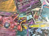 a lot of pokemon cards sitting on a table