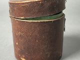 a brown box with a green lid sitting on a table