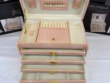a pink case with three drawers on top of it