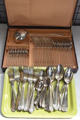 a tray with silverware in it on a table