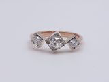 an image of a three stone diamond ring on a white background