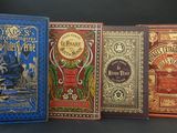 four books are lined up in a row on a table