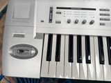 a white electronic keyboard sitting on a blue chair