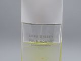un flacon de parfum « Eau Dissy » posé sur une surface blanche