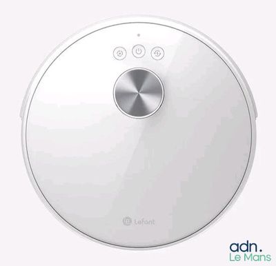 a close up of a robot vacuum cleaner on a white surface