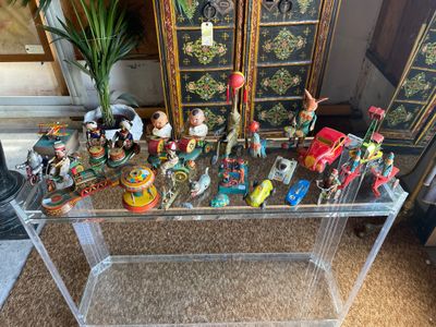 a glass table with a bunch of figurines on it