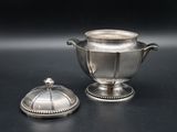 an antique silver plated sugar and creamer with a domed lid