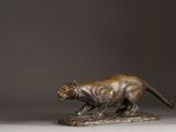 an image of a bronze statue of a cat on a rock