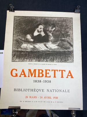 an old poster of a woman reading a book on a table