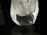 a glass vase with a liquid inside of it on a table