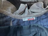 three men ' s jeans are stacked on top of each other in a pile