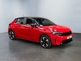 a red car is parked in a room with a white wall