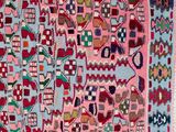 a pink and blue rug with a pattern on it