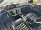 a black leather car with a steering wheel and dashboard