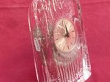 a glass clock that is sitting on a table