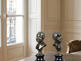 three busturines on a table in a living room