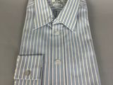 a blue and white striped dress shirt on a gray surface