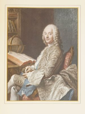portrait of a man sitting at a desk with a book in his lap