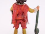 a figurine of a man in a red outfit holding a baseball bat