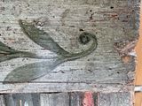 a close up of a piece of wood with a bird on it