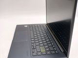 a black laptop with a yellow sticker on the keyboard