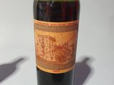 a bottle of wine sitting on a table next to a bottle of wine