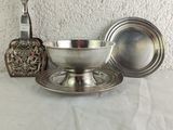 a silver bowl and a silver spoon on a table