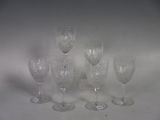 five wine glasses sitting on a table with a white background