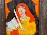 a painting of a woman holding a book and a candle