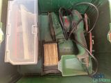 a green box with tools inside of it on the floor