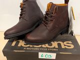 a pair of brown boots sitting on top of a box