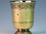 a gold cup that is sitting on a table