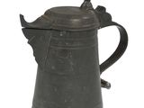 a black metal coffee pot with a bird on top