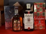 a bottle of whisky and a box of cigarettes on a table